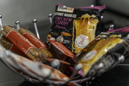 a basket filled with hot dogs and other snacks at Comfy Stay 1 Bedroom Apartment in Rugby