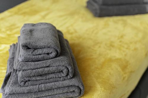 a stack of towels sitting on top of a table at Comfy Stay 1 Bedroom Apartment in Rugby