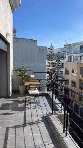 a balcony with a table and chairs on a building at TheCasaEdition Gauthier Residency City Center in Casablanca