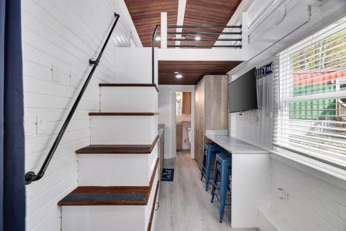 a tiny house with a staircase in a kitchen at Camptel Poconos in Albrightsville