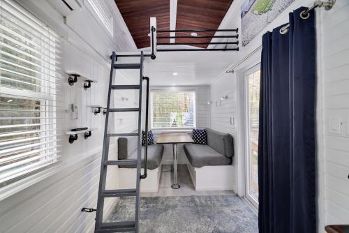 a tiny house with a ladder and a couch at Camptel Poconos Lodging in Albrightsville