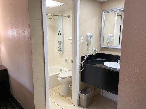a bathroom with a sink and a toilet and a phone at Studio 6 Suites North Richland Hills TX in North Richland Hills