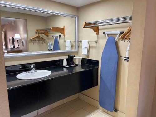 a bathroom with a sink and a mirror at Studio 6 Suites North Richland Hills TX in North Richland Hills