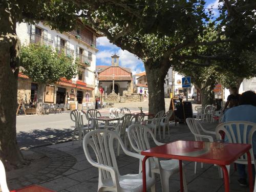 a group of tables and chairs on a city street at NovaCand in Candelario