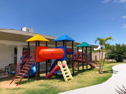 Zona de juegos infantil en Apartamento em House Clube