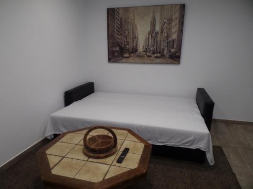a room with two beds and a basket on a table at Apartamento Buen Dia airport Malaga- playa-Torremolinos in Málaga