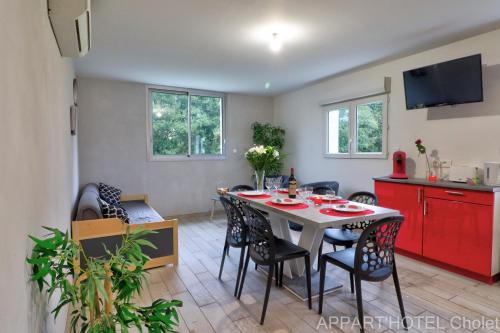 a kitchen and living room with a table and chairs at Appart hotel Cholet Carteron in Cholet