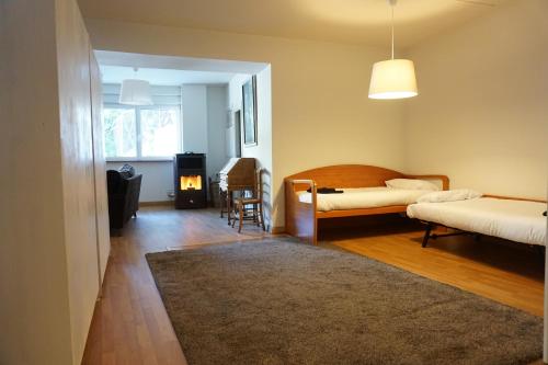 a bedroom with two beds and a table and a chair at Loft Puerto de Navacerrada in Cercedilla