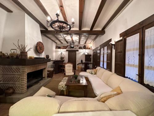 a living room with a couch and a fireplace at La Flor del Granado in Torrijos