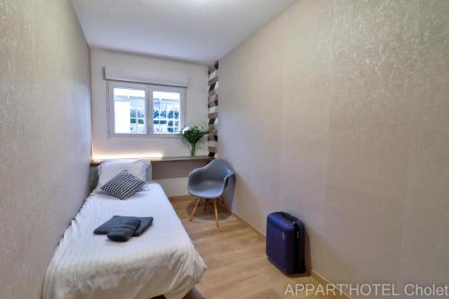 Ένα ή περισσότερα κρεβάτια σε δωμάτιο στο Appart hotel Cholet Carteron