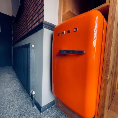 an orange object is sitting next to a garage at THE ITALIAN GREYHOUND in Great Glen