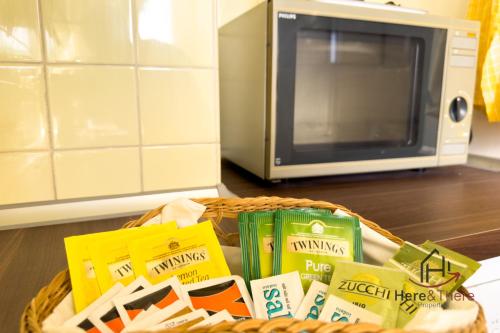 a basket of food in front of a microwave at Beaches 1 min away - Free WiFi - Smart TV - AC in Albisola Superiore
