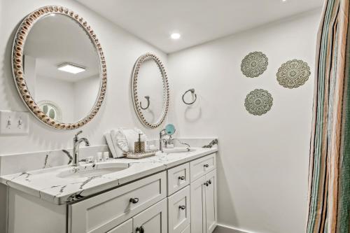 a bathroom with two sinks and mirrors on the wall at Coastal Gem of Murrells Inlet in Myrtle Beach