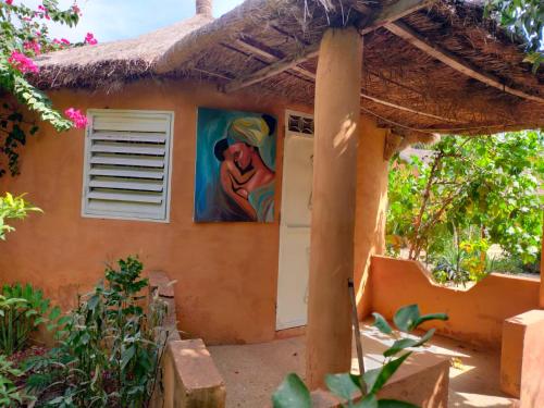 a painting on the side of a house at Campement Baobab chambres d'hotes 15mn de l'aeroport in Poponguine