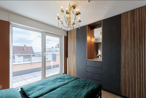 a bedroom with a bed and a large window at Designer Penthouse in St Johannes, toller Ausblick über den Dächern Nürnbergs in Nürnberg