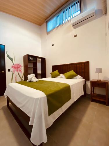 a bedroom with a large bed and a window at Casa Macaw in Fortuna