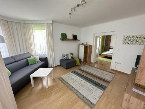 a living room with a couch and a table at Haus Apricum - schön wohnen & gratis parken in Vienna