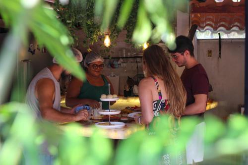 a group of people sitting around a table at Villa Éden in Alter do Chao