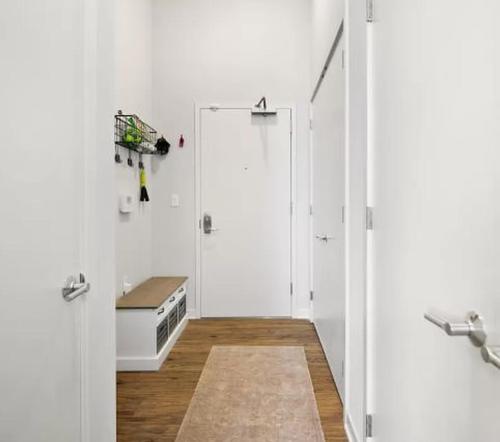 a white room with a shower and a door at Restful Studio Apartment in NYC! in New York