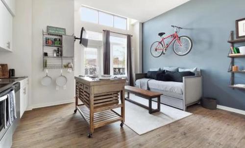 a living room with a bike hanging on the wall at Restful Studio Apartment in NYC! in New York