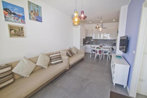a living room with a couch and a kitchen at Garden Floor Condo with Promenade Sea View in Nice