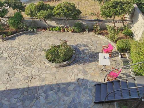 an overhead view of a patio with two pink chairs at Elia boutique apartment in Thiva