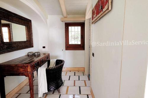 a room with a wooden desk and a mirror at Villa Mare Blu - Porto Rotondo in Porto Rotondo
