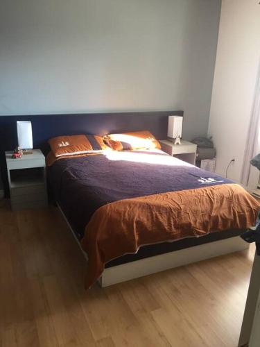 uma cama num quarto com duas mesas e duas lâmpadas em Maison entière piste motoneige. em Sorel