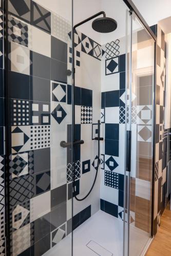 a bathroom with a shower with blue and white tiles at Taggami b&b in Nocera Inferiore
