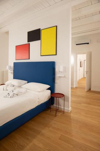 a bedroom with a blue bed and a table at Taggami b&b in Nocera Inferiore