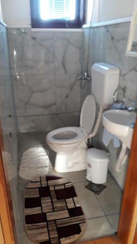 a bathroom with a toilet and a sink at Rooms Struga in Struga