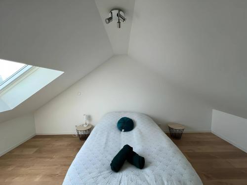 Una habitación con una cama con zapatos negros. en La Chaleureuse - Centre Parigné - 5p - Rêve au Mans en Parigné-lʼÉvêque