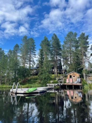 a boat docked at a dock on a lake at Aurora Wilderness Cones in Gällivare