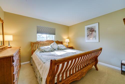 a bedroom with a wooden bed and a window at Canal-Front Clay Township Gem Boat and Jet Ski Lift 