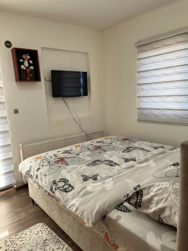 a bedroom with a bed and a flat screen tv at Apartman's Ana Pale-OC Jahorina No.3 in Pale