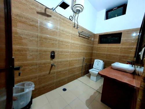 a bathroom with a shower and a toilet in it at Hotel Gajender Niwas Sun City A Boutique Stay in Jodhpur