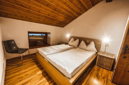 a bedroom with a bed and a desk and a chair at Ferienwohnung Curuna in Scuol