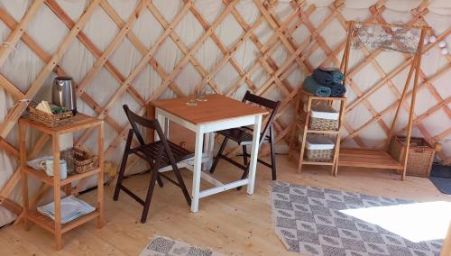 een kamer met een tafel en stoelen in een yurt bij Jurte 