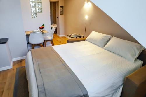 a bedroom with a large white bed in a room at Vittorio 73 Luxury Apartment in Turin
