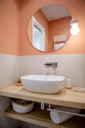 a bathroom with a white sink and a mirror at 633 APPIA DESIGN ROOM in Rome
