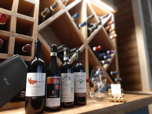 a row of wine bottles sitting on a shelf at Hotel Valle Pesio Ristorante in Chiusa di Pesio