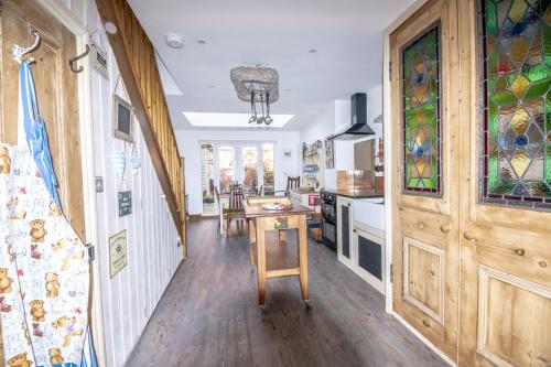 a kitchen with a wooden door and a table at 2-Bedroom Stylish, Cosy & Bright Cottage, Pet Friendly, Sleeps 5, Titchfield Village - by Blue Puffin Stays in Titchfield