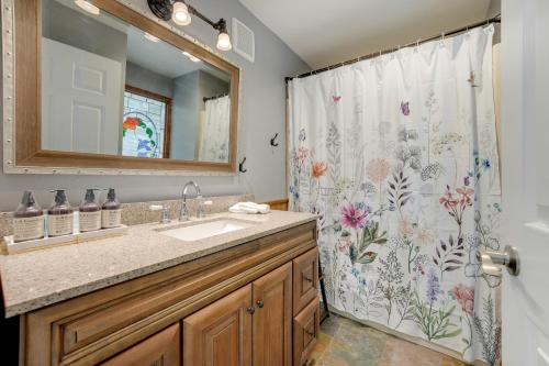 a bathroom with a sink and a shower curtain at Cassopolis Vacation Home - Walk to Diamond Lake! in Cassopolis