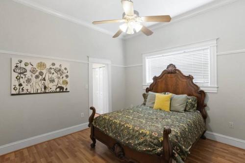 a bedroom with a bed and a ceiling fan at The Bays Best Bungalow in Tampa