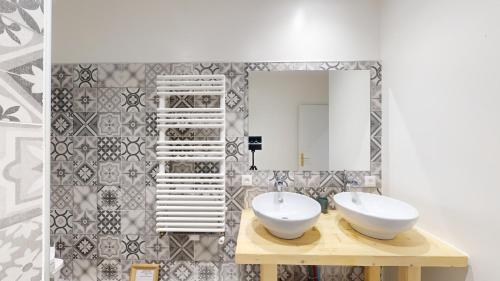 a bathroom with two sinks and a mirror at Les Terrisses - Chambres d'hôtes avec piscine in Saint-Félix-Lauragais