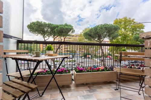 a balcony with a table and chairs and a large window at 633 APPIA DESIGN ROOM in Rome