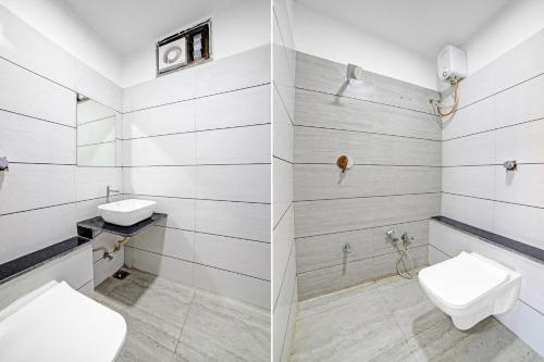 a bathroom with two sinks and a toilet at HOTEL TAPOVAN IN in Ahmedabad