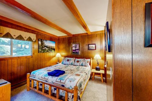 a bedroom with wooden walls and a bed in a room at 60073 Wallowa Lake Hwy (upper unit) in Joseph