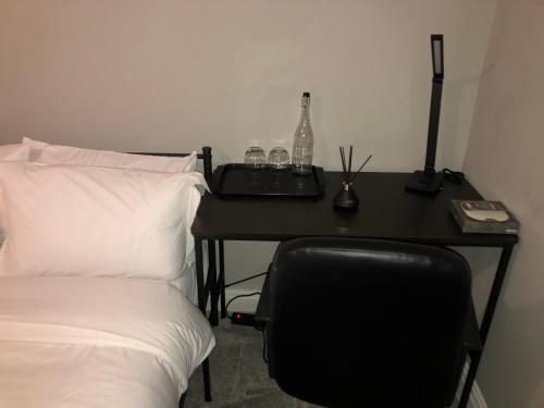 a desk with a chair next to a bed at Cozzy Living in Killingbeck
