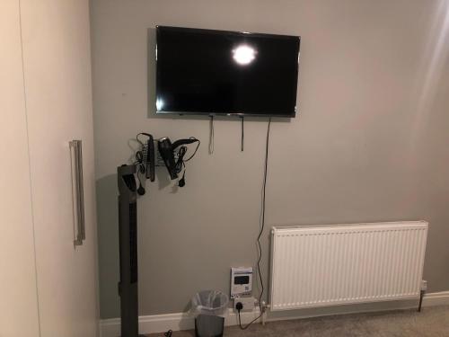 a flat screen tv hanging on a wall at Cozzy Living in Killingbeck